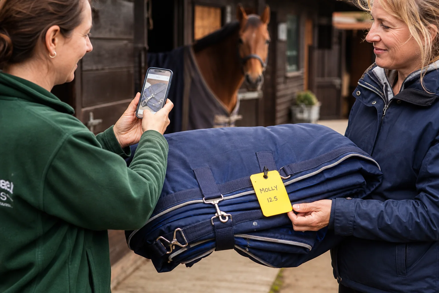 A clean folded horse rug with its yellow tag being checked and returned to its owner